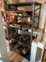 Metal shelving unit stocked with various items like paint cans, tools, and office supplies, used for visual reference only; items not included.
