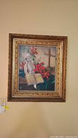 Frontal image of the signed religious themed painting on board showing bust figure, open book, poinsettias, and cross within ornate gold frame.