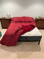 Full front view of assembled queen bed with bedding and nightstands