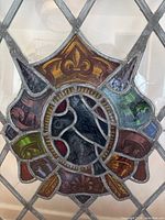 Central heraldic stained glass medallion and surrounding diamond panes