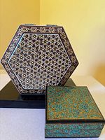 Hexagonal and square boxes closed showing top designs