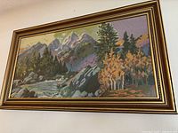 Full view of framed needlepoint hanging on wall