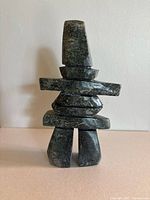 Front view of serpentine Inukshuk sculpture