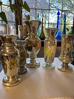 All five mercury glass vases grouped