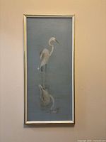 Full view of framed stork painting on wall
