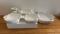 Five casserole dishes and one mug arranged on table