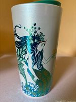 Front view showing mermaid artwork and lid