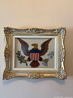 Front view of framed American eagle embroidery