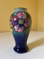 Full view of vase front showing Clematis decoration and colour gradient