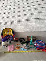 Full lot of assorted Dr. Seuss and vintage collectible items arranged on table against pegboard background