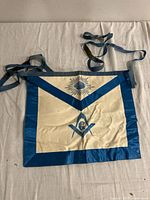 Full front view of the vintage Master Freemason apron showing blue border and central symbols.