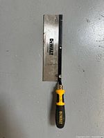 Front view of DeWalt hand saw showing blade, spine and handle