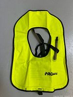 Front view of neon yellow Promate inflatable snorkel vest showing inflator tube and straps