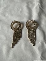 Front view of both earrings on fabric background