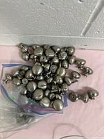 Pile of cabinet knobs showing quantity and finish