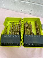 Open yellow Ryobi case showing full range of titanium-coated drill bits