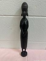 Full front view of carved ebony wood female figure