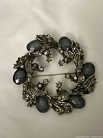 Front view of circular brooch showing stone arrangement and clasp