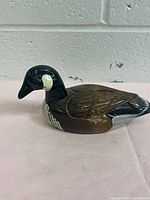 Left side view of carved wooden duck figurine