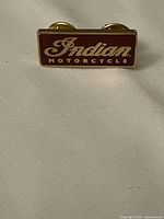 Front view of rectangular enamel "Indian Motorcycle" lapel pin