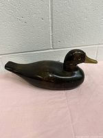 Side view of full wooden duck figurine