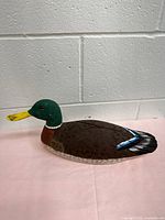 Left side profile of carved and painted wooden mallard decoy