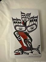 Lid showing Indigenous artwork "King Fisher" by Richard Hunt