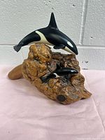 Full view of burlwood sculpture with two orcas