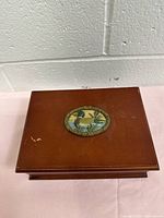 Top view showing duck motif inset on wooden lid