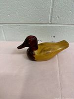 Side view of carved wood duck decoy showing color and shape
