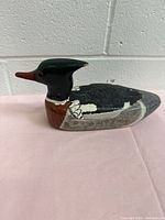 Profile view of carved wooden duck showing paint scheme