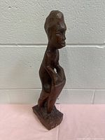 Front view of carved wooden drummer figurine