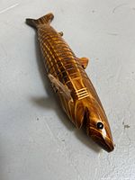 Full view of carved segmented wood fish