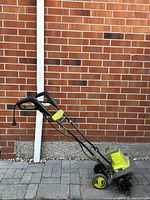 Side view of Sun Joe electric tiller showing handle, wheels, and motor housing