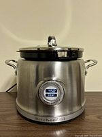 Front view of KitchenAid stainless steel multi-cooker with digital display showing 450°F and 'Sear' mode active.