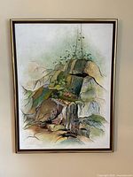 Frontal view of the framed rocky landscape painting with visible stylized rock formations and green plant details