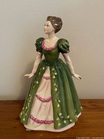 Front and angled views of the Royal Doulton Gemma figurine, showing its details and colors.