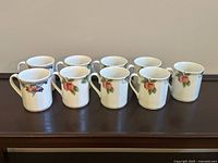 Nine Royal Doulton mugs arranged in two rows showing grape and autumnal fruit patterns.