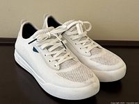 Front angle view of the white Vessi women's shoes size 8 showing the knit textile upper, lacing and rubber sole.