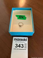 Ring placed inside a blue box with a green 10k label, showing overall condition and presentation.