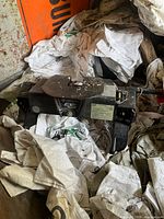 5th wheel hitch placed on storage area with bags and debris around. Main body and base visible.