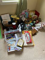 Wide view of full lot showing various office supplies including desk lamp, film box, cards, gift bags, ribbons, and pen container