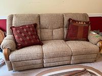 Front view of the 3-seat sofa in upright position with throw pillows on each outer seat.