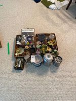 Wide view of all items together on carpet floor showing two boxes containing kitchenware and decor.