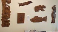Overview of six indigenous style wood carvings arranged on wall