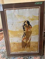 Framed limited edition art print showing abstract Native American bird design in earthy colors with signed and numbered details, size label 28x36 visible.