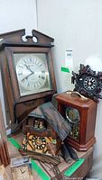 Group shot of all clocks including Carillon wall clock, two cuckoo clocks, and mantel clock