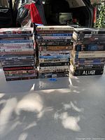 Photo showing many DVD cases stacked in three columns with visible titles.