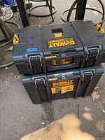 Two DeWalt ToughSystem 2.0 toolboxes stacked on top of each other, viewed from the front, showing logos, latches, and general condition.