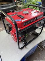 Red gasoline generator with black frame and exposed wiring, labeled King Canada Power Force 1500W.